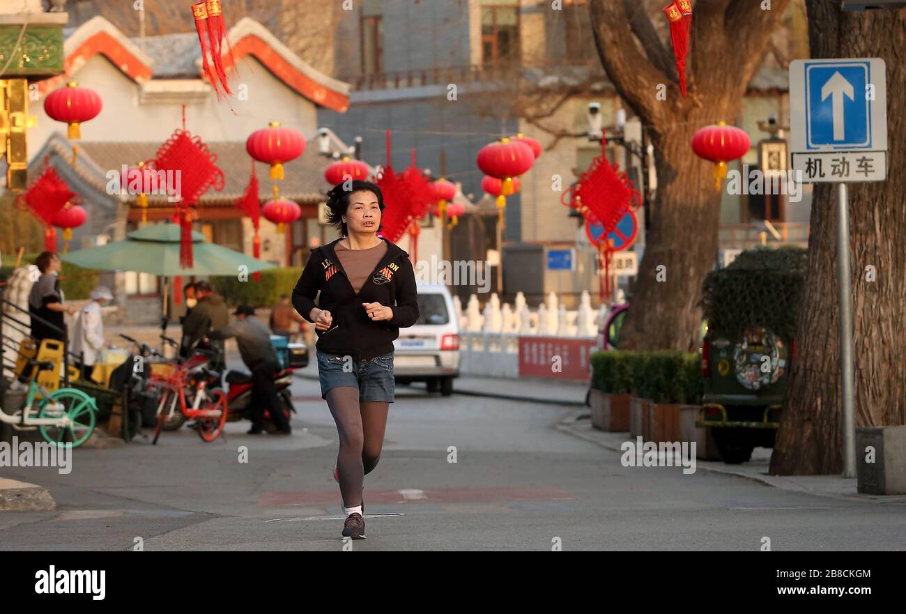 Peking, China. März 2020. Eine Chinesin joggt ohne schützende Gesichtsmaske, ein ungewöhnlicher Anblick in der Stadt, da die Bedrohung durch das tödliche Coronavirus (Covid-19) am Samstag, 21. März 2020, in Peking verblasst. China hat zum ersten Mal seit Beginn der Pandemie keine neuen lokal übertragenen Coronavirus Fälle gemeldet. Foto von Stephen Shaver/UPI Credit: UPI/Alamy Live News Stockfoto