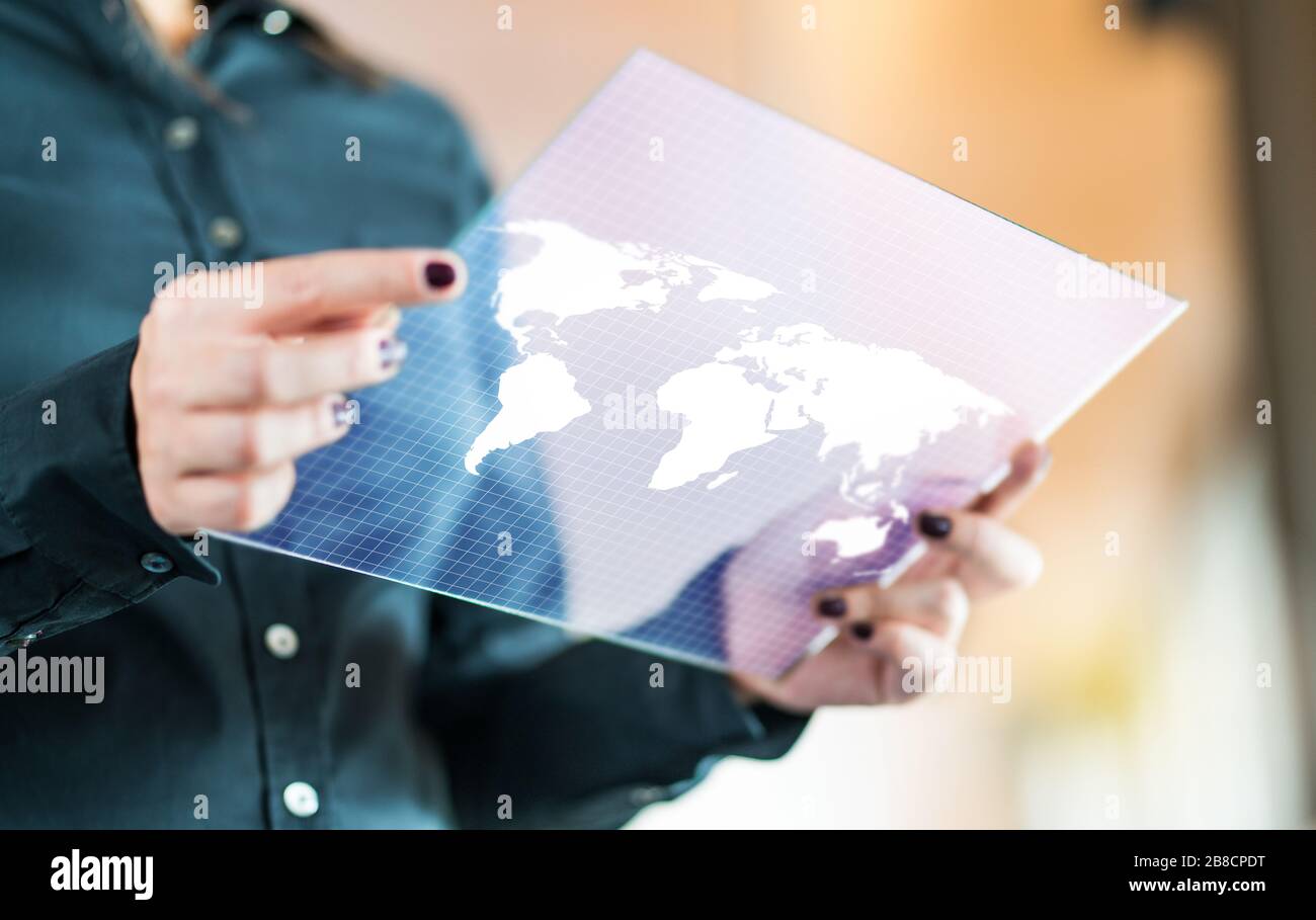 Modernes globales und internationales Business Technology Konzept. Geschäftsfrau mit futuristischem, transparentem Tablet mit Weltkarte auf dem Bildschirm. Stockfoto