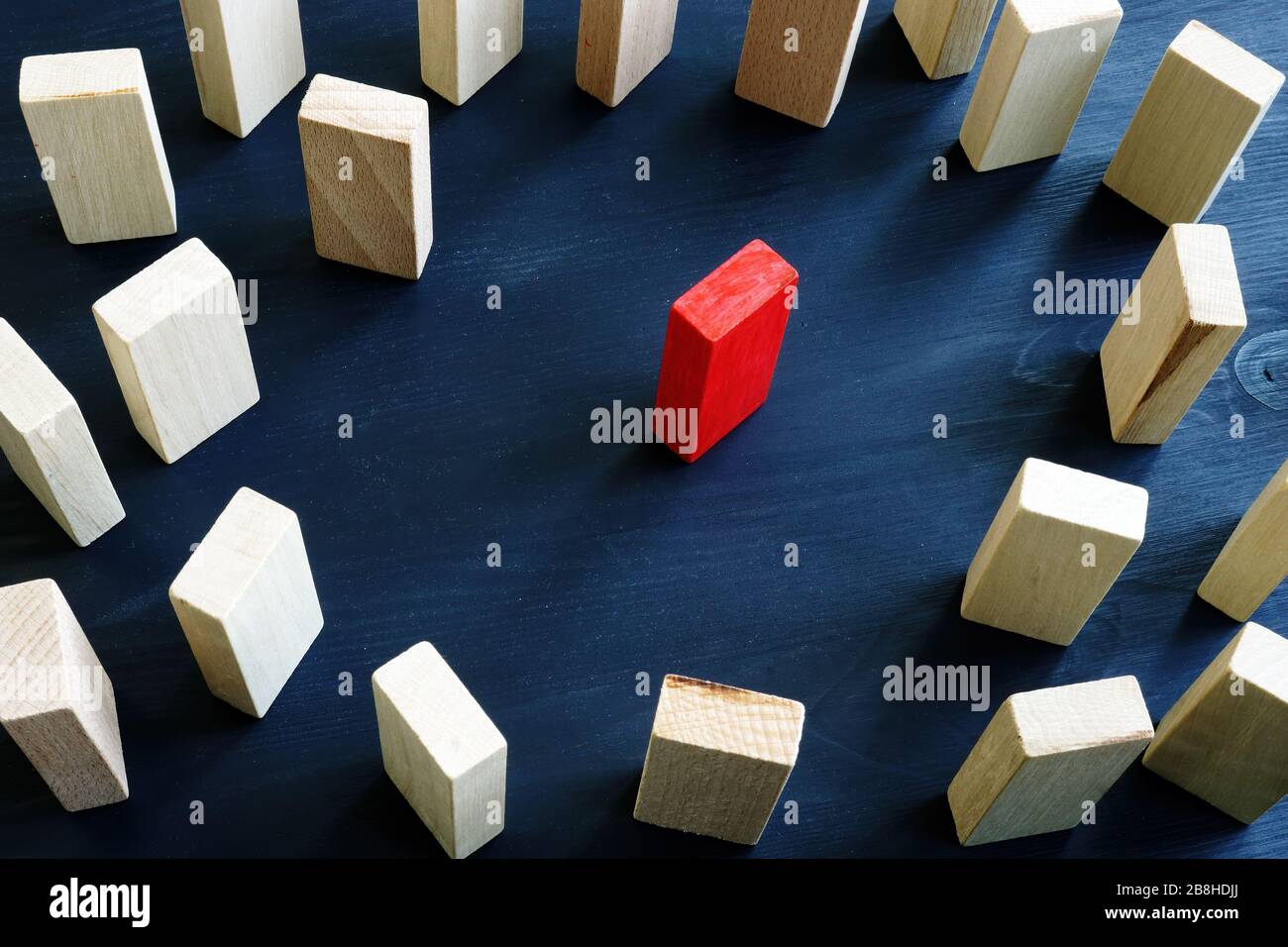 Konzept für Integration, Diversität und Diskriminierung. Roter Block im Kreis aus Holzklößen. Stockfoto