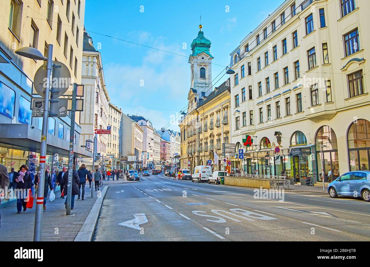 WIEN, ÖSTERREICH - 19. FEBRUAR 2019: Die belebte Landstraße Landstraßer Hauptstraße mit altem Wohnbau und Glockenstuhl der Kirche St. Elisabeth von Ungarn, am Februar Stockfoto