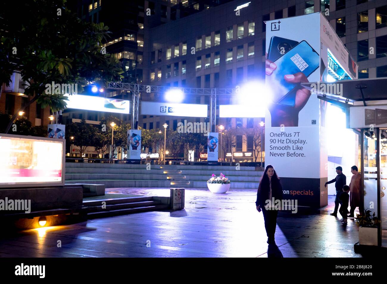Freilichttheater des Cyberhub mit bunten Lichtern, Werbeplakaten, Sitzbereichen und Wolkenkratzern im Hintergrund Stockfoto