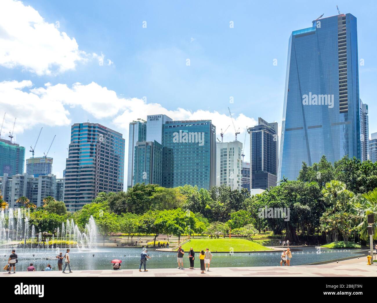 Büro- und Wohnhochhäuser und Brunnen in Symphony Lake und Touristen genießen einen Tag im KLCC Park Kuala Lumpur Malaysia. Stockfoto