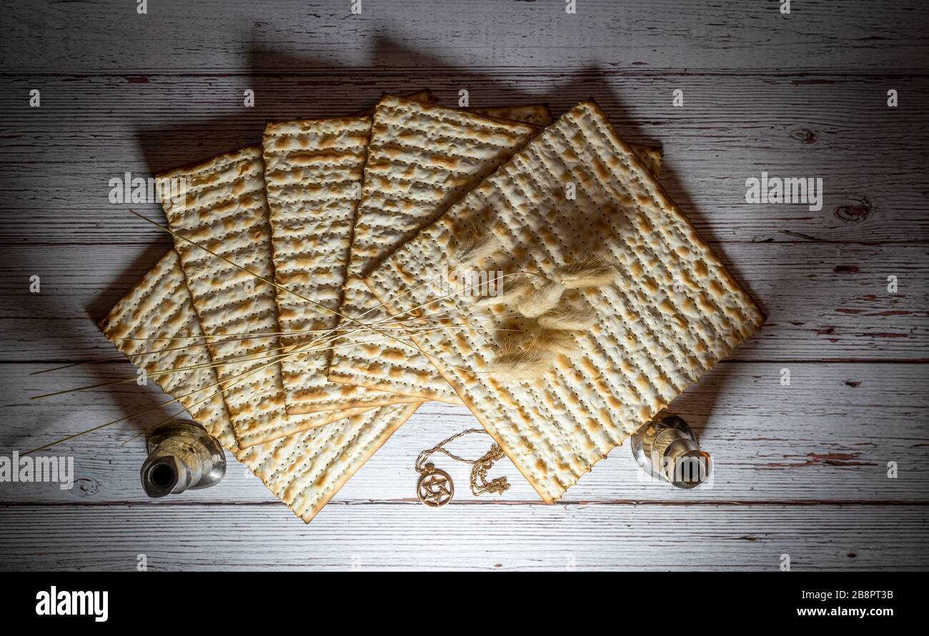 Passahmatzos, zwei Kerzenhalter, getrocknete Blumen und David Halskette auf Holzhintergrund Stockfoto Passahmatzos, zwei Kerzenhalter, getrocknete Blumen und David Halskette auf Holzhintergrund Stockfoto