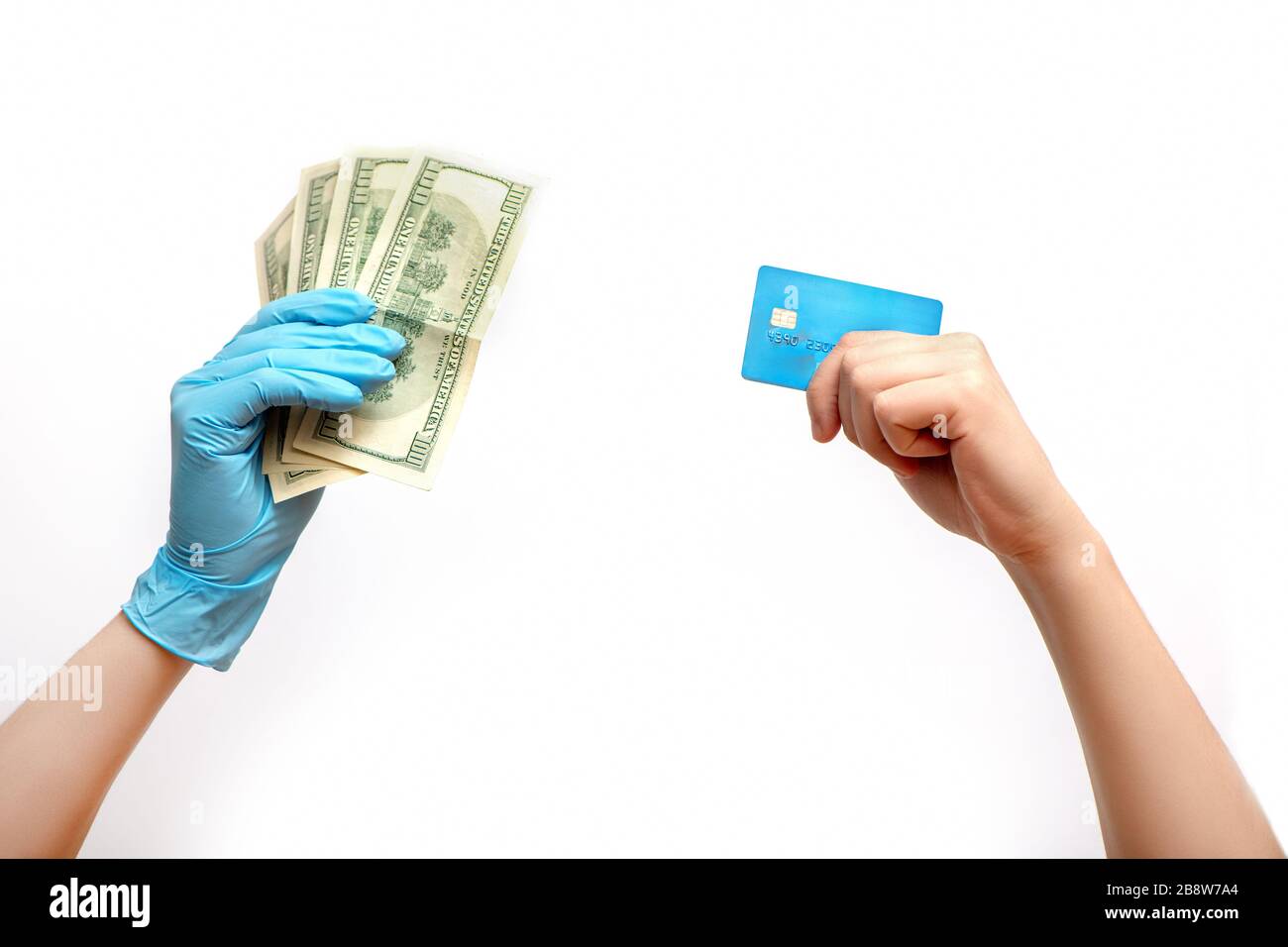 Hand mit Kreditkarte und Hand in medizinischen Handschuh mit Bargeld isoliert auf weißem Hintergrund. Stockfoto