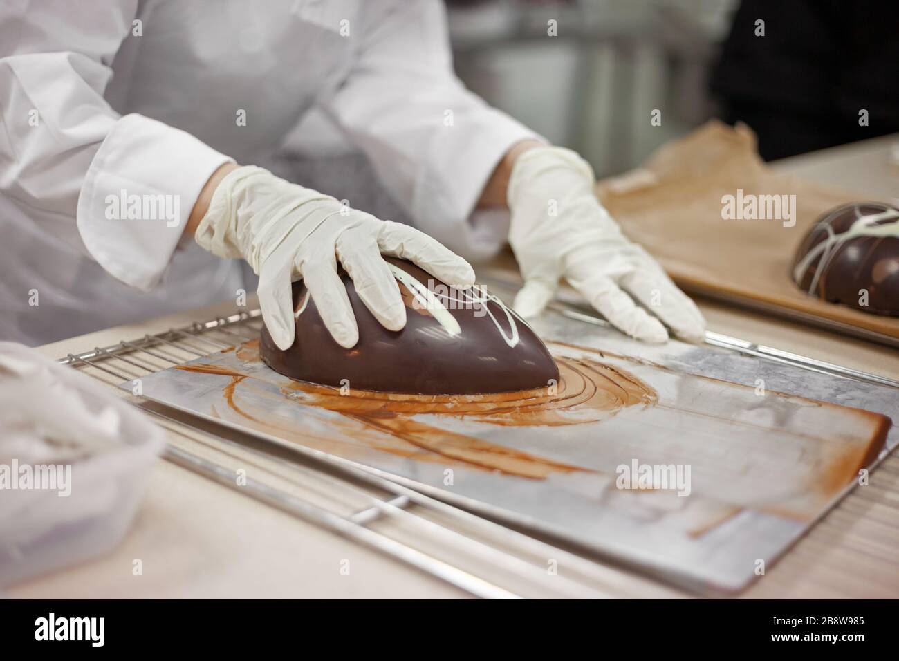 Schokolade machen. schokoladen-ostereier machen. Schokoladenfabrik. Stockfoto