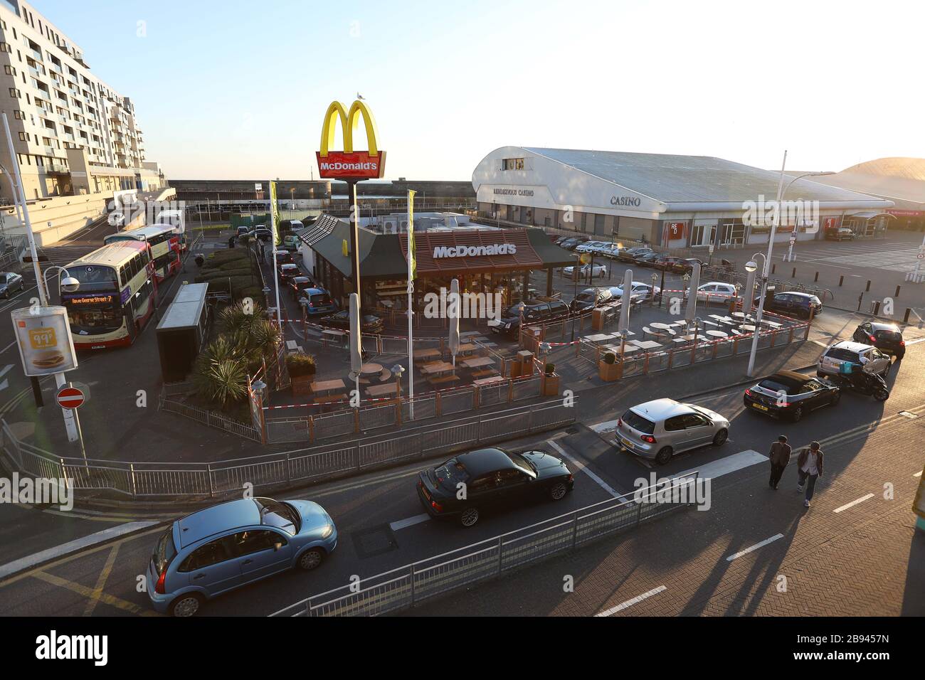 Brighton, Großbritannien. März 2020. McDonalds Drive-Thru-Kunden, die dort kurz vor dem Schließen des Fast-Food-Restaurants Autos anstehen, sind wegen des Coronavirus Ausbruchs in der Tür. Credit: James Boardman/Alamy Live News Stockfoto