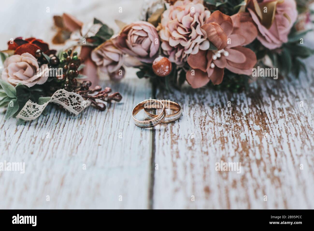 Romantisches Hochzeitsset mit Ringen. Rustikale Paar Hochzeit Komposition mit Ringen, Blumenkrone und boutonniere. Passende Hochzeitsaccessoires. Stockfoto