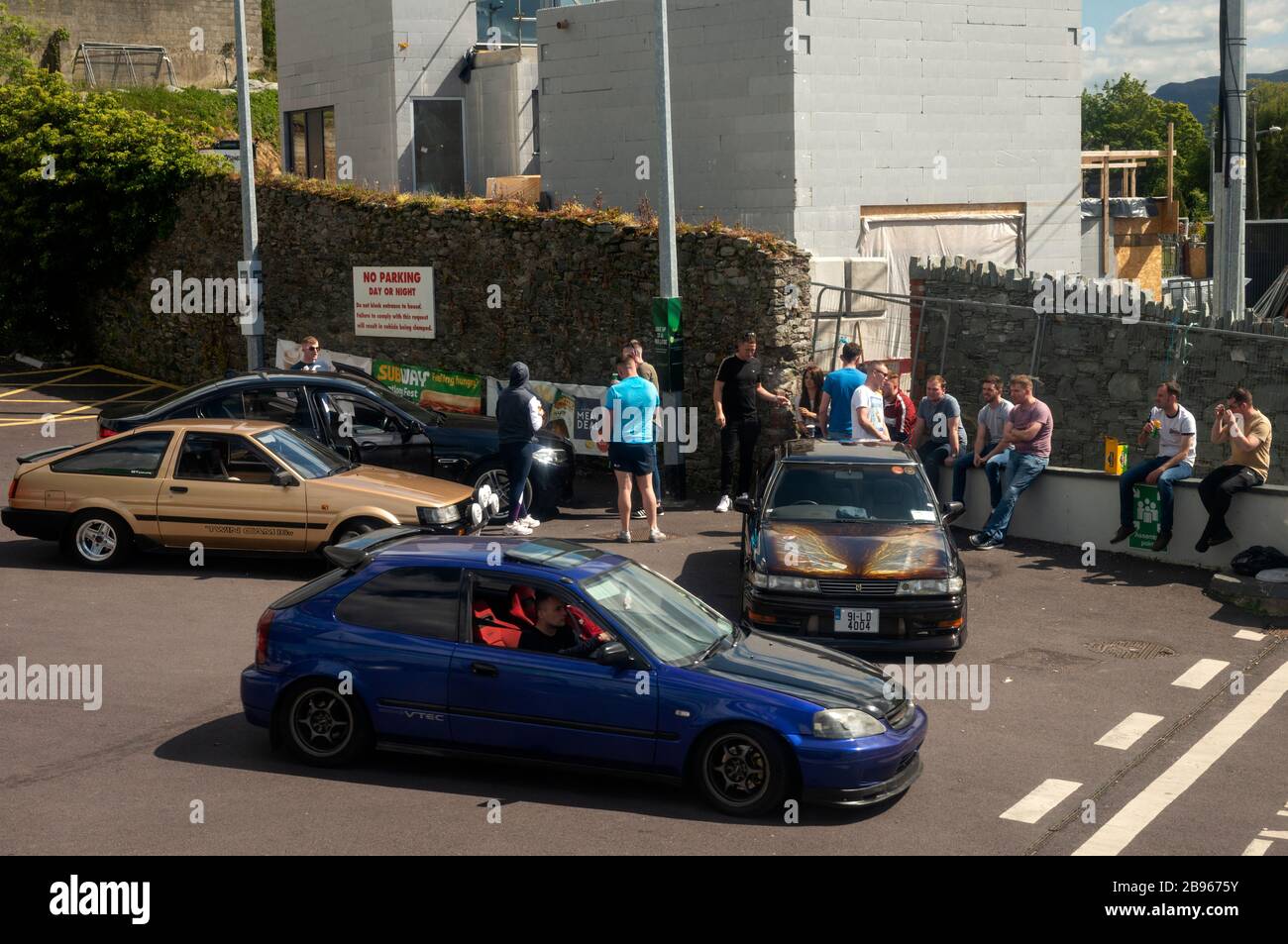 Gruppe junger Männer mit umgebauten Autos, die in den Straßen von Killarney, County Kerry, Irland, herumhängen und Spaß haben. Stockfoto