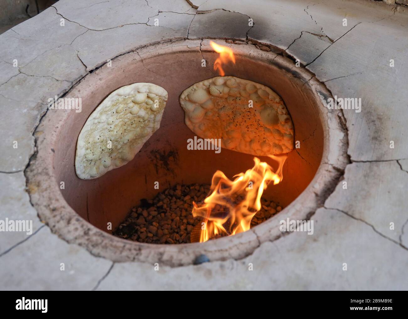 Brotbacken im traditionellen Tandoor Ofen im Khaneye Amoo Mash Reza Haus (Haus des Onkels Mesh Reza) im Dorf Kavirabad, Varamin, Teheran Stockfoto