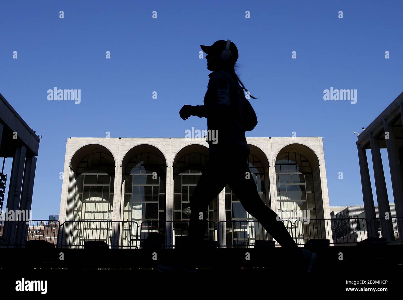 New York, USA. März 2020. Eine Frau jogg am Dienstag, 24. März 2020 im Lincoln Center in New York City. Der Staat New York berichtet von den meisten Fällen und Todesfällen im Land mit mehr als 23.230 bestätigten Fällen und 188 Todesfällen. Foto von John Angelillo/UPI Credit: UPI/Alamy Live News Stockfoto