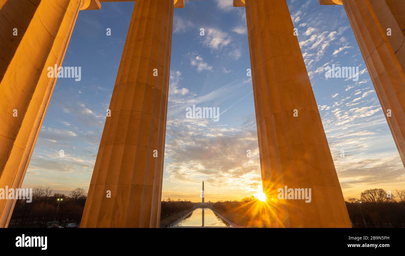 Die Sonne geht über Washington, D.C., und das Lincoln Memorial Reflecting Pool, wie es von innen aus dem Lincoln Memorial und seinen Steinpfeilern zu sehen ist Stockfoto