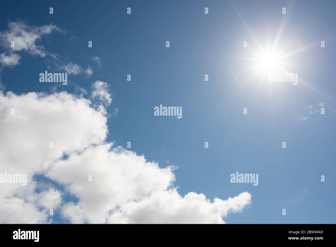 Wettervorhersage leicht bewölkte Sturmwolken bestahlen den blauen Himmel mit Sonnenschein Stockfoto