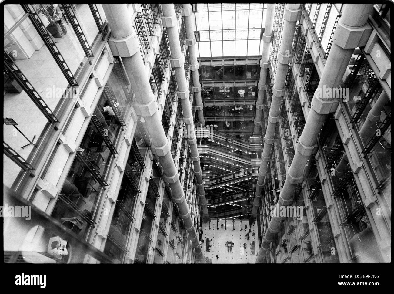 City of London. Lloyd's of London Insurance Trading Floor fotografierte 1988 mit Genehmigung. Lloyd's of London, allgemein bekannt als Lloyd's, ist ein Versicherungs- und Rückversicherungsmarkt in London, Großbritannien. Im Gegensatz zu den meisten seiner Mitbewerber in der Branche handelt es sich nicht um eine Versicherungsgesellschaft, sondern Lloyd's ist eine Körperschaft des Lloyd's Act von 1871 und nachfolgende Parlamentsakte. Sie ist als teilweise veränderter Markt tätig, auf dem mehrere in Syndikaten zusammengefasste Finanzdienstleister zusammenkommen, um Risiken zu bündeln und zu verteilen. Diese Underwriter, oder 'Members', sind a Stockfoto