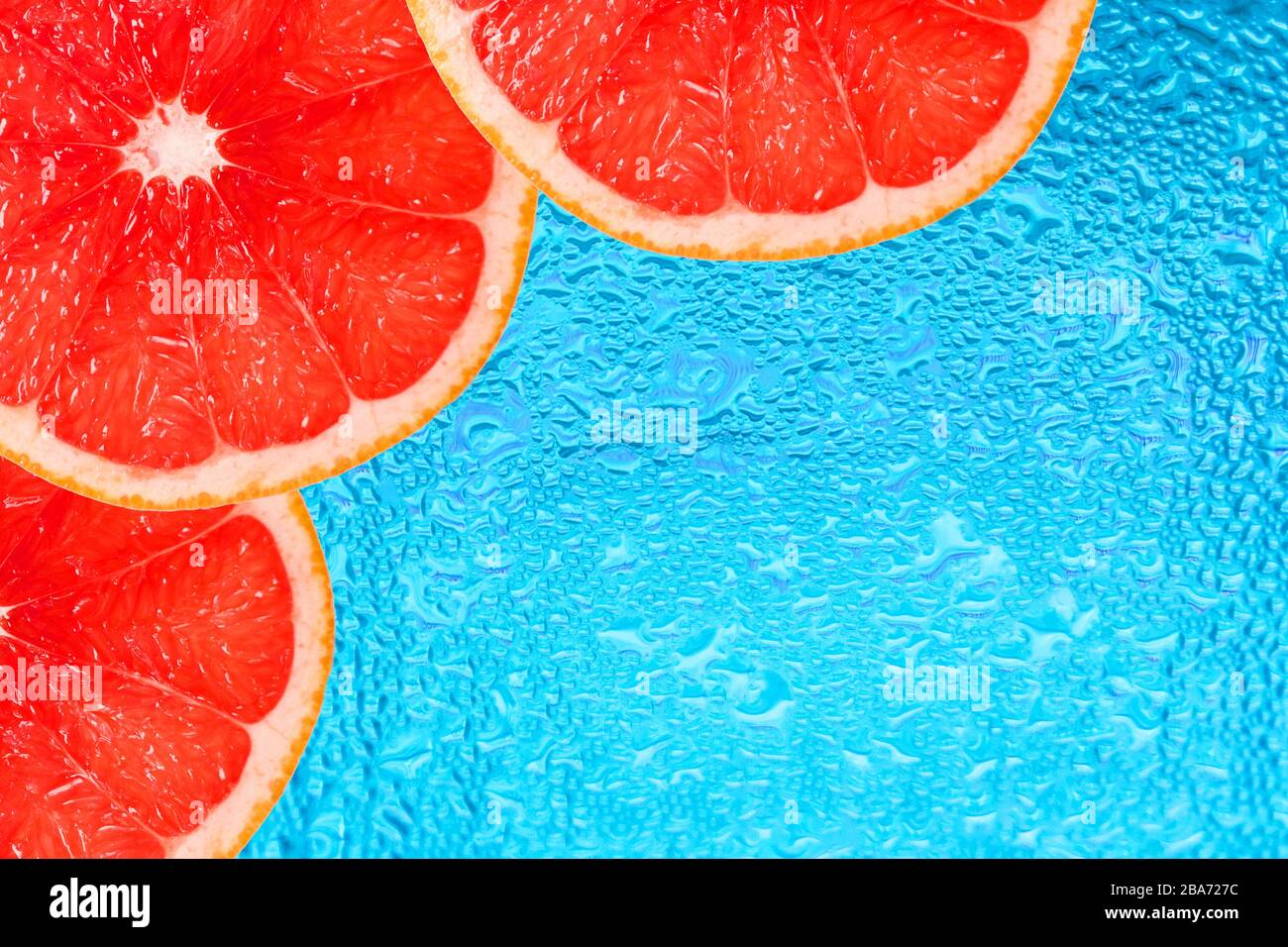 Grapefruit Scheiben auf dem Hintergrund von Wassertropfen. Kopierbereich. Stockfoto