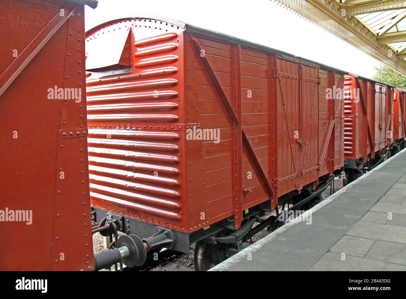 Ein Zug der klassischen Güterwagen an einem Bahnhof. Stockfoto