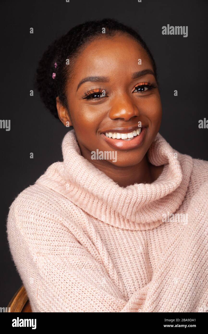Porträt einer schönen jungen Frau lächelnd und mit Wollpullover Stockfoto