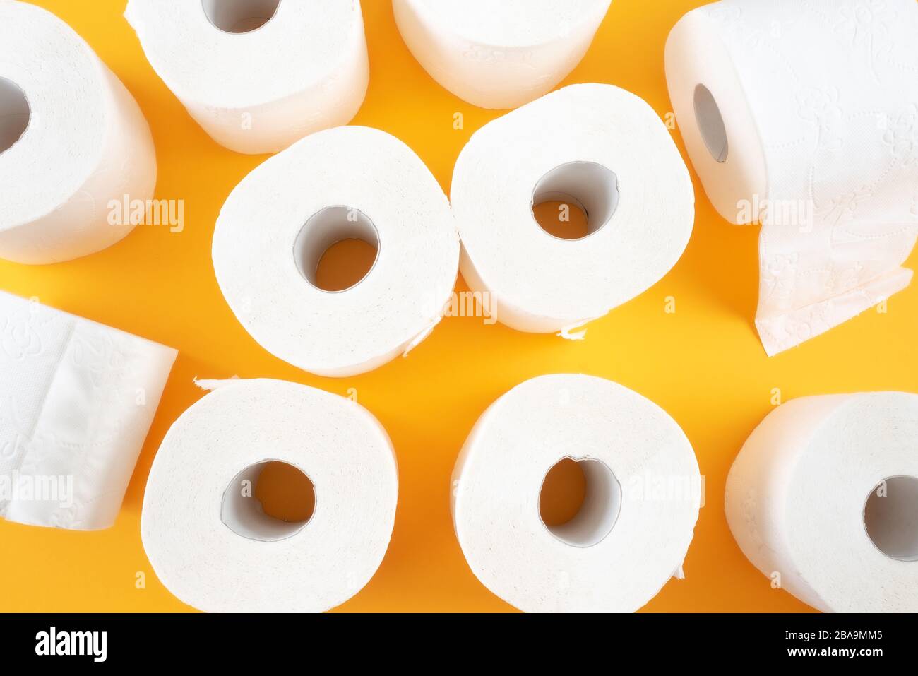 Draufsicht der toilettenpapierrollen auf orangefarbenem Hintergrund Stockfoto