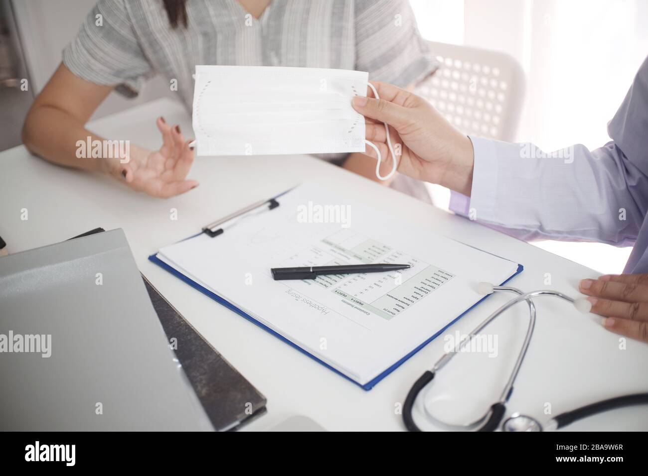 Ärztin der weiblichen Medizin arbeitet mit beratender Patientin am Tisch. Stockfoto