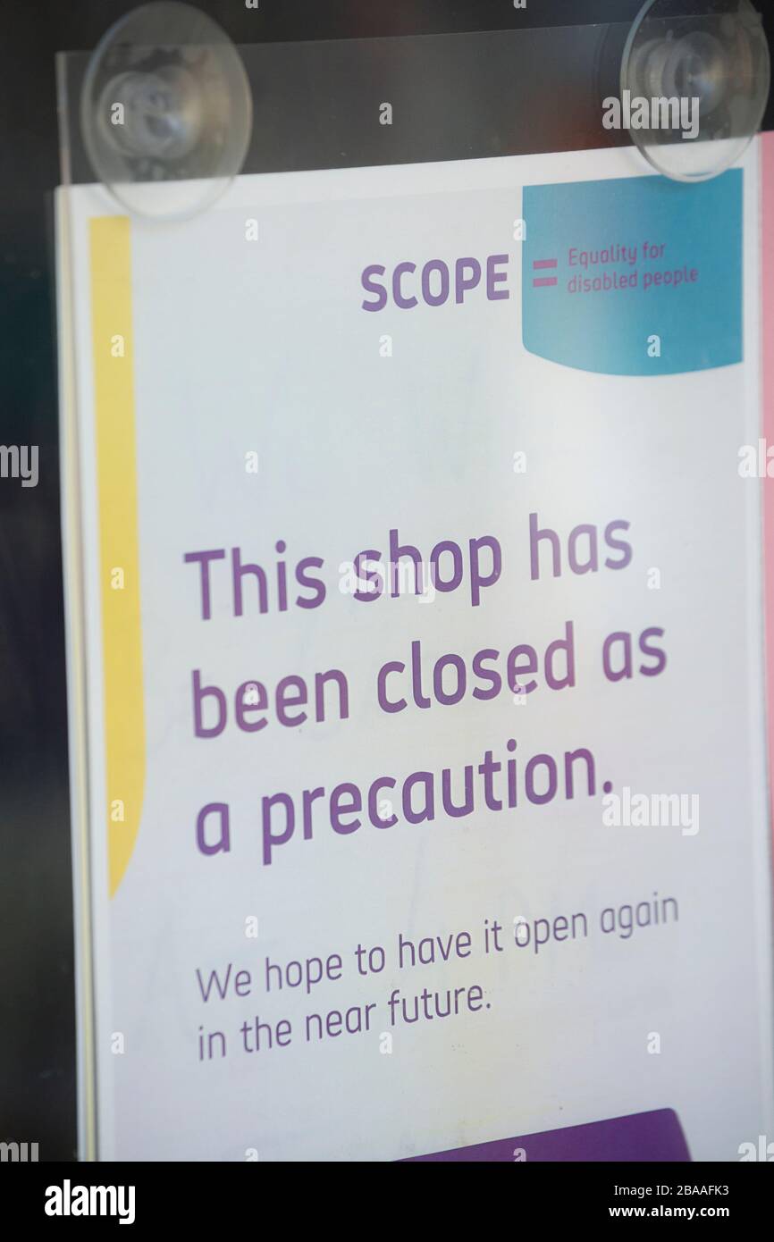 Ein Schild im Fenster eines Scope Charity Shops in Gillingham Dorset zeigt an, dass das Geschäft wegen des Ausbruchs des Coron nun für Geschäfte geschlossen ist Stockfoto