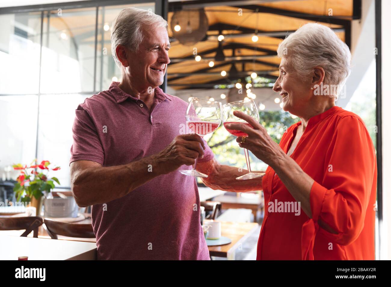 Kaukasisches Senioren-Paar trinkt zu Hause Wein zusammen Stockfoto