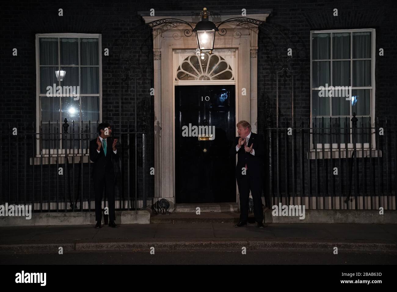 Premierminister Boris Johnson und Kanzler Rishi Sunak vor der 10 Downing Street, London, schlossen sich mit nationalem Applaus für die NHS von ihren Türstufen, Fenstern und Balkonen an, um ihre Anerkennung für alle NHS-Arbeiter zu zeigen, die beim Kampf gegen das Coronavirus helfen. Stockfoto