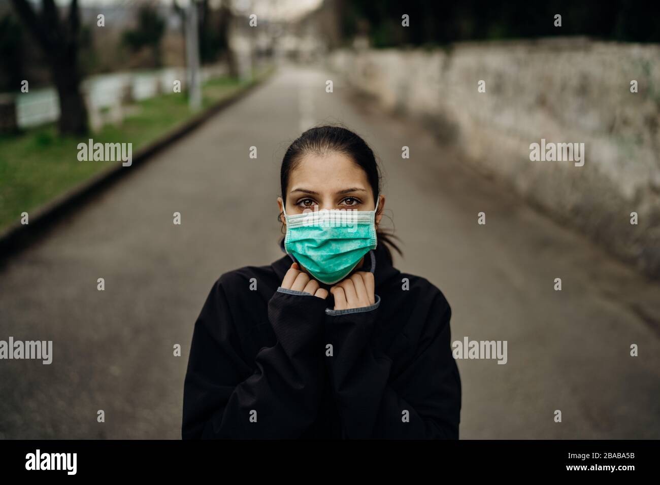 Erschrockene kranke Frau mit Schutzmaske.an Infektionskrankheit erkrankt.infizierter Patient leidet unter Krankheitssymptomen.Panik und Angst vor Infe Stockfoto