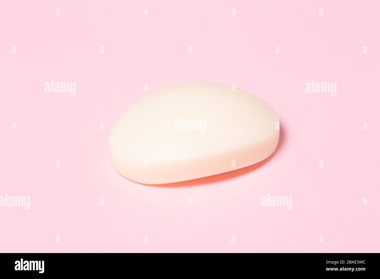 Weißer Seifenbalken auf pinkfarbenem Hintergrund. Hugien-Konzept. Stockfoto