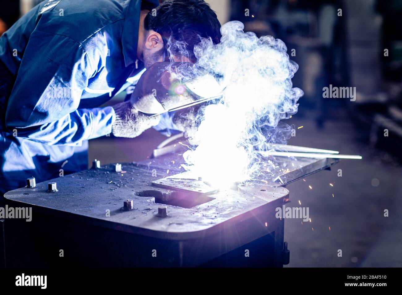 Arbeiter schweißen Metall, das in der Stahlindustrie arbeitet. Stockfoto