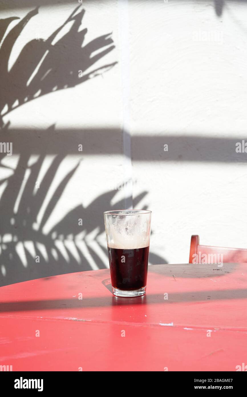 Ein halbes Pint Guinness draußen auf einem Tisch. Stockfoto