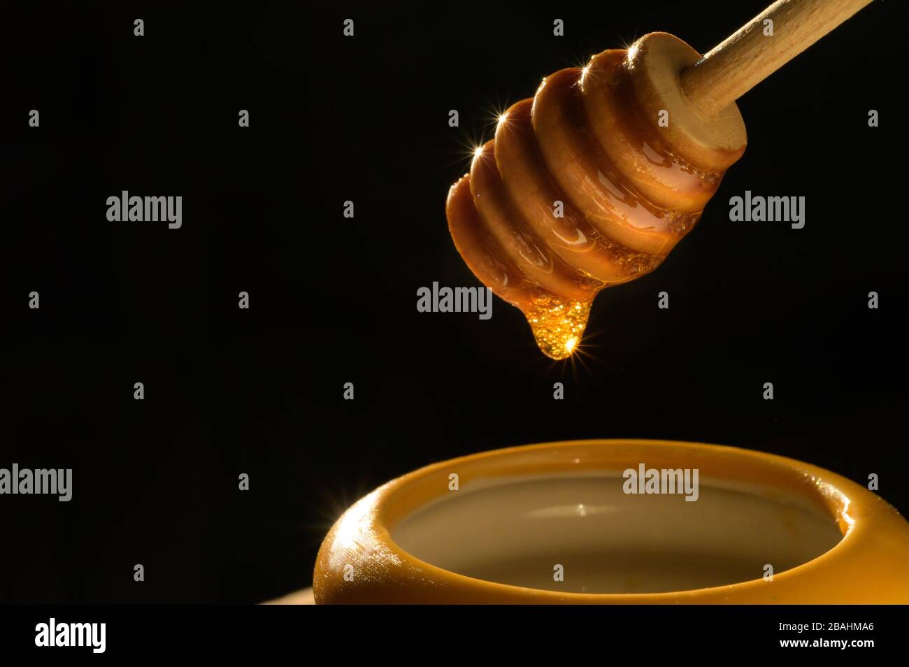 Lecker tropfende Honigtopffotografie - Bilder zu niedrigen Lebensmittel-Schlüsseln - hochwertige Lebensmittelfotos - Produktfotografie Stockfoto