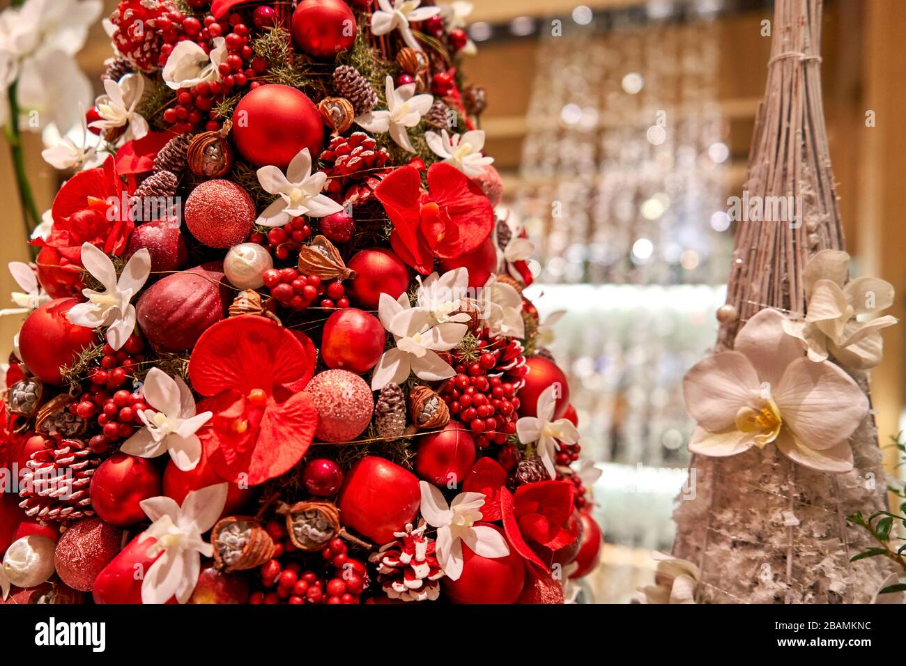 Weihnachtsbaum mit schön beleuchteten Dekorationen im Hintergrund Stockfoto