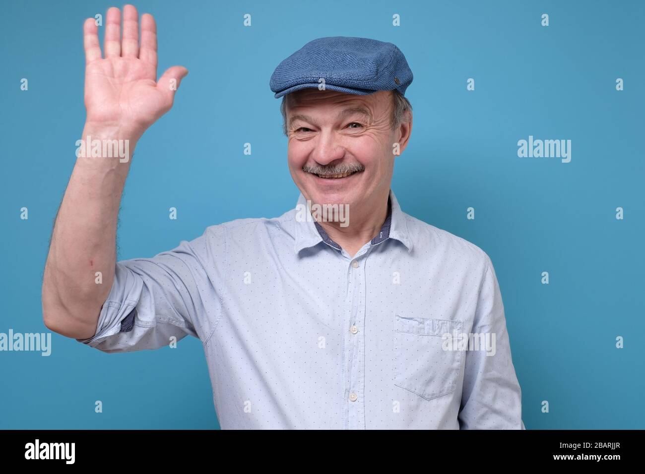 Reifer hispanischer Mann winkt Hand seinen Freund willkommen Stockfoto