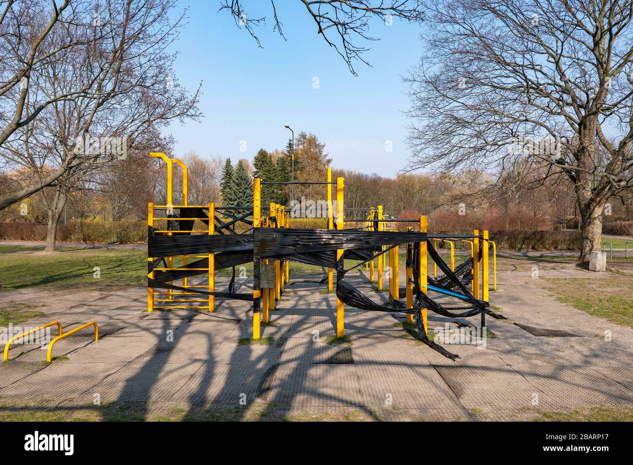 Sportgeräte im Freien im öffentlichen Stadtpark, geschlossen für eine Coronavirus-Krankheit COVID-19 Pandemie, mit einer schwarzen Folie gesichert Stockfoto