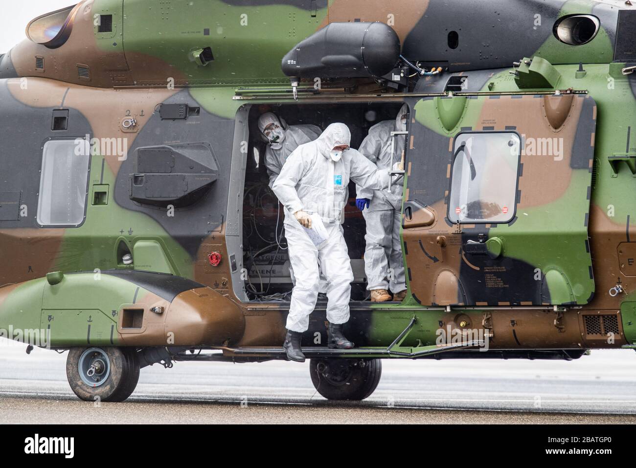 29. März 2020, Nordrhein-Westfalen, Mülheim an der Ruhrgebiet: Rettungskräfte in Schutzkleidung steigen am Flughafen aus einem Militärhubschrauber. Zuvor wurden zwei Patienten aus Metz-Frankreich nach Mühlheim gebracht, um im Universitätsklinikum Essen behandelt zu werden. Foto: Marcel Kusch / dpa Stockfoto