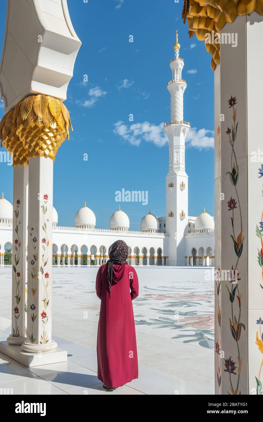 Unidentifizierte Frau, die die große Moschee in Abu Dhabi, VAE, besucht Stockfoto