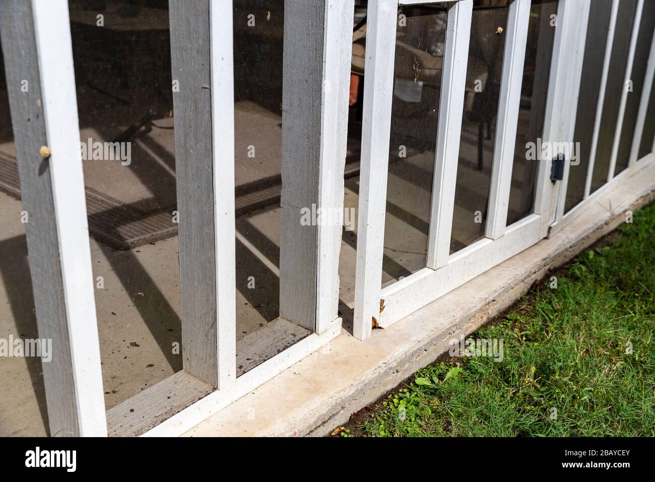 Holz-Screen-Tür auf der hinteren Veranda mit verfaultem Holz Stockfoto