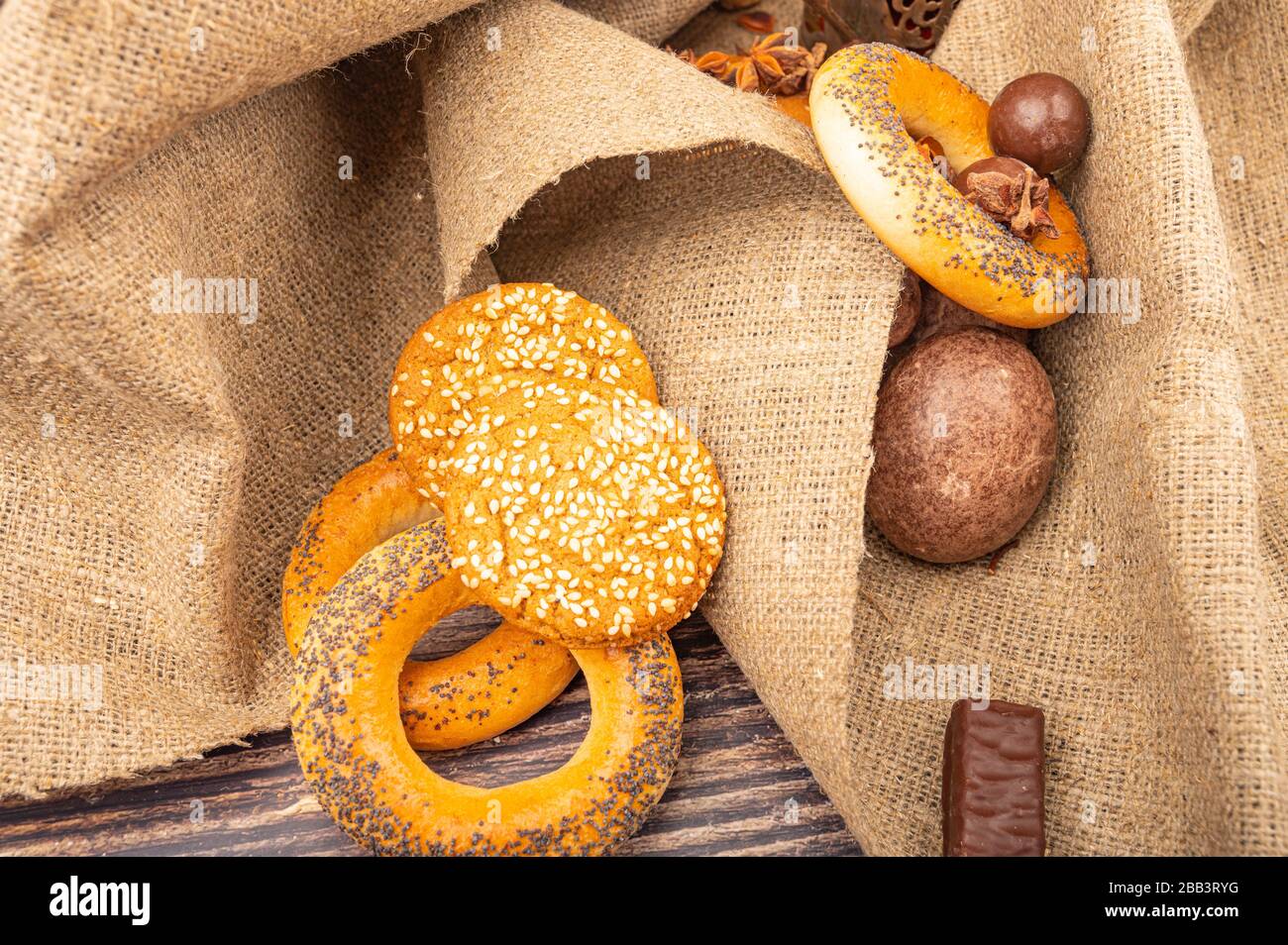 Bagels, Plätzchen, SchokoladenLebkuchen und Schokolade auf einem Stoffhintergrund mit rauer Textur. Nahaufnahme Stockfoto