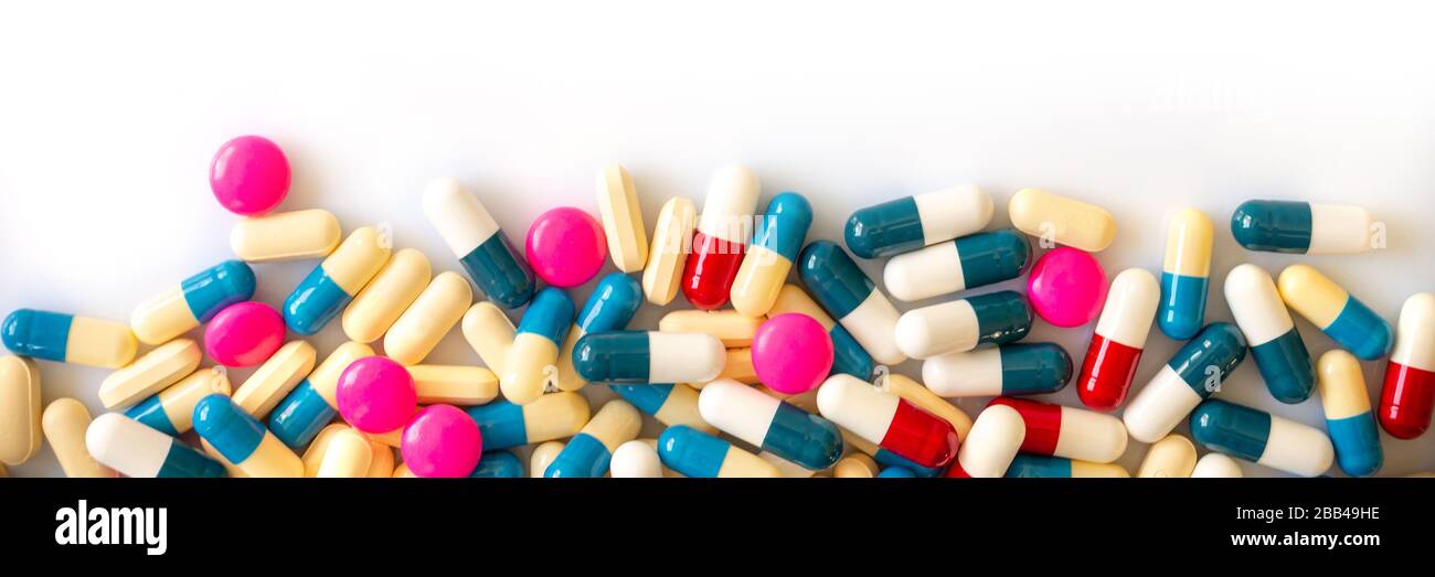 Bunte Pillen auf weißem Hintergrund, Gesundheit und Medikamente, Coronavirus, Kovid-19-Behandlungskonzept Stockfoto