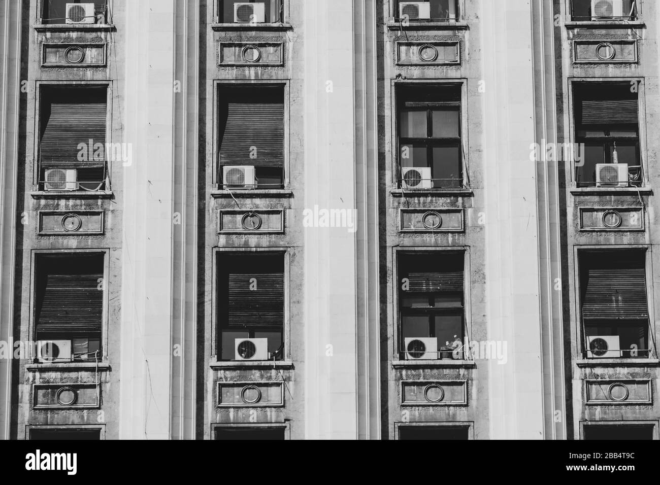 Das Äußere eines alten gebäudes im sowjetischen Stil mit Fensterklimamaschinen. Stockfoto