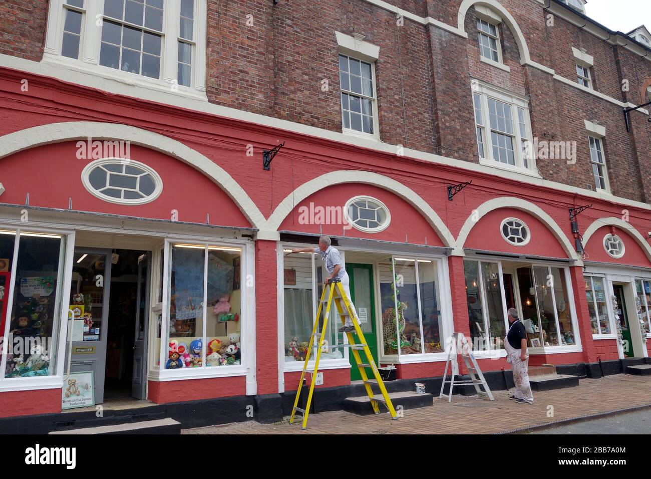 Maler und Dekorateure malen Geschäfte und öffentliches Gebäude in Ironbridge Shropshire UK Stockfoto