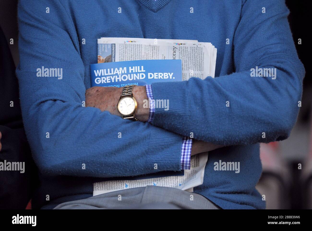 Racegoers überprüfen die Rennkarte auf den Tribünen Stockfoto