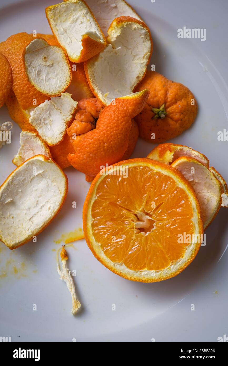Scheibe Zitrusorange gesunde Früchte und Reste auf einem weißen Teller Stockfoto
