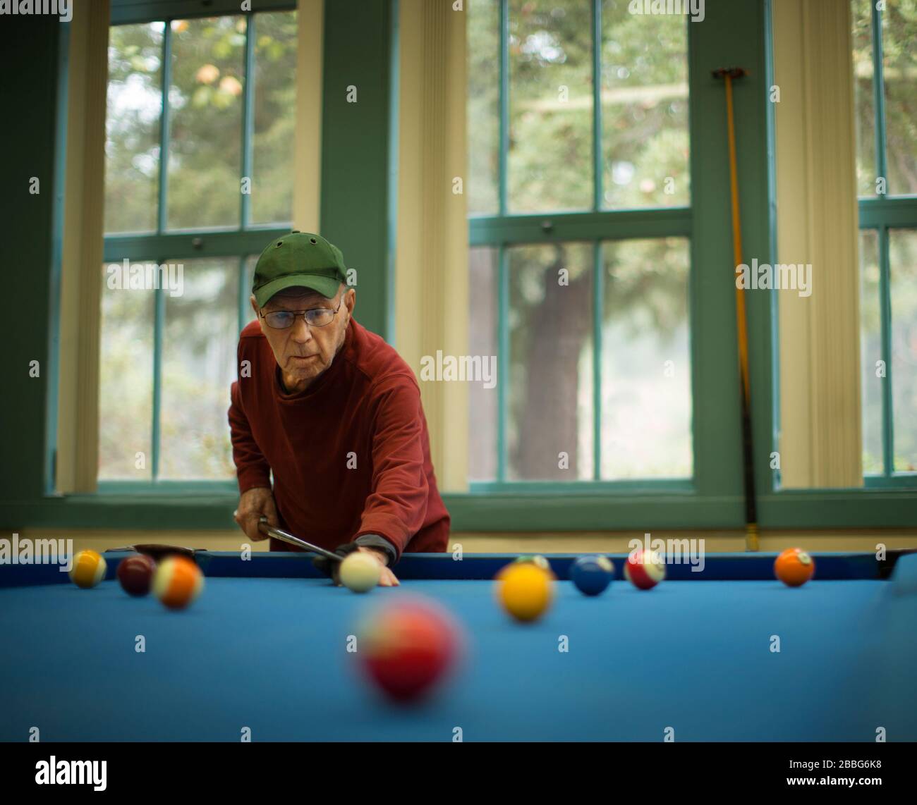 Der aktive Senior konzentrierte sich auf ein Spiel mit Pool. Stockfoto
