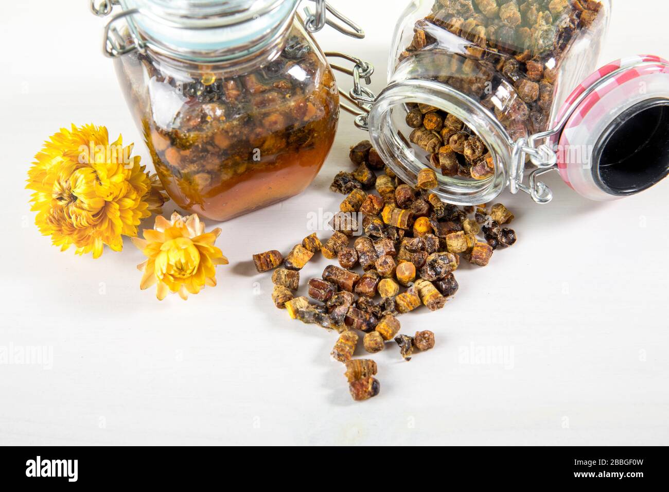 Alternative Arzneimischung aus Honig und Bienenbrot (fermentierte Blume und Pflanzenpollen von Honigbienen) im kleinen Glasbecher. Stockfoto