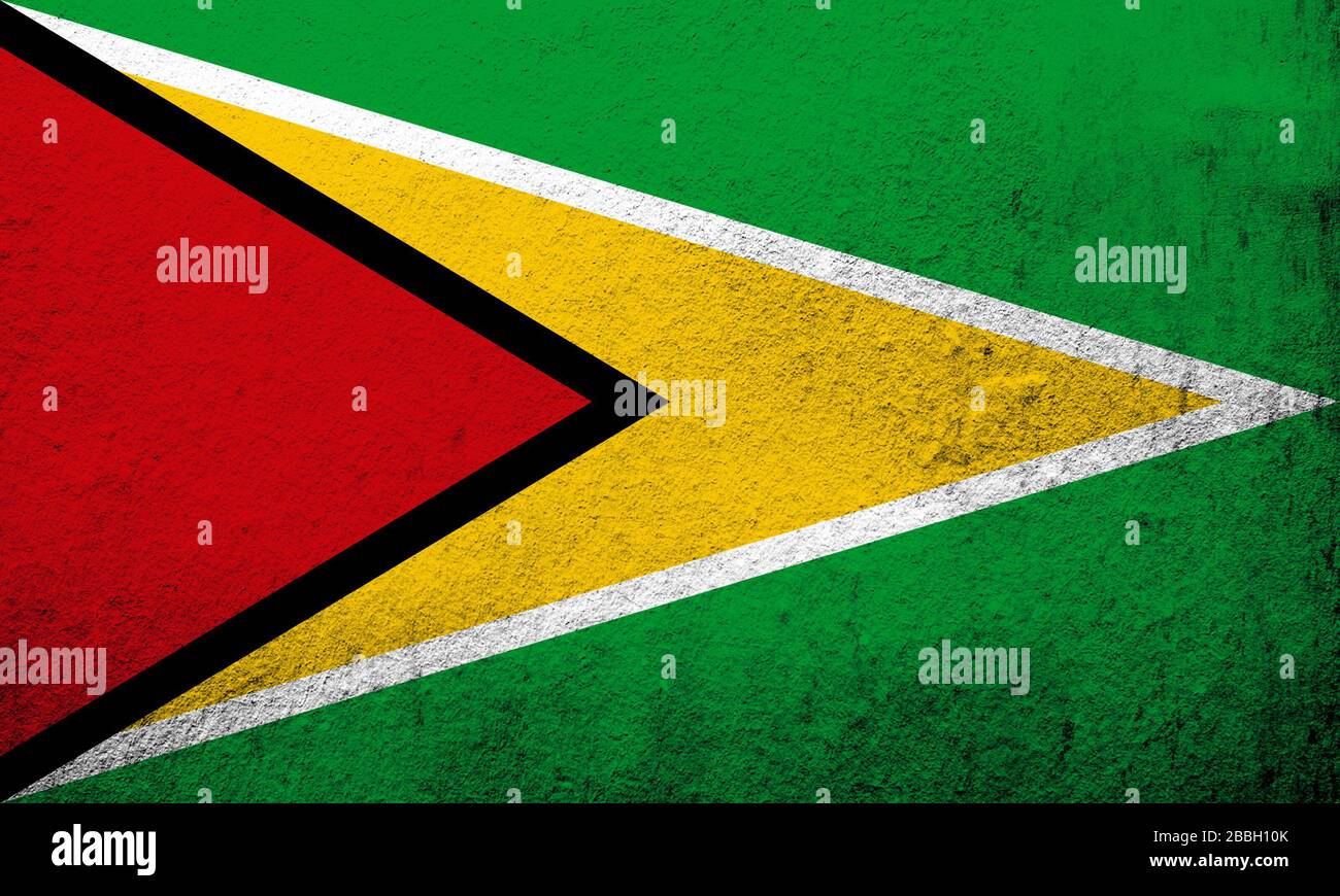 Die Nationale Flagge der kooperativen Republik Guyana ist das Goldene Pfeilrad. Grunge Hintergrund Stockfoto