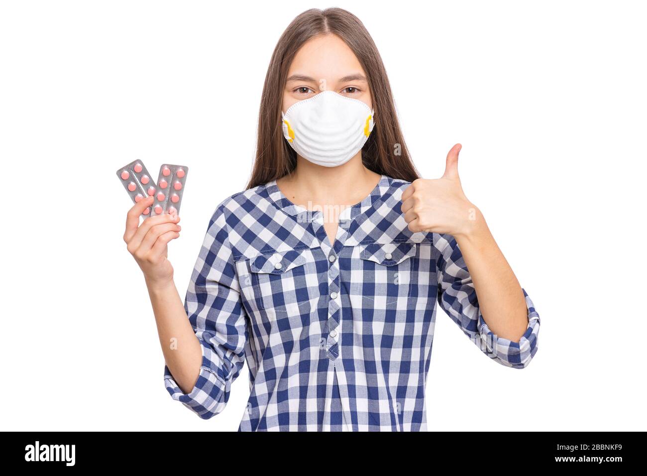 Teen Mädchen in Maske mit Tabletten Stockfoto