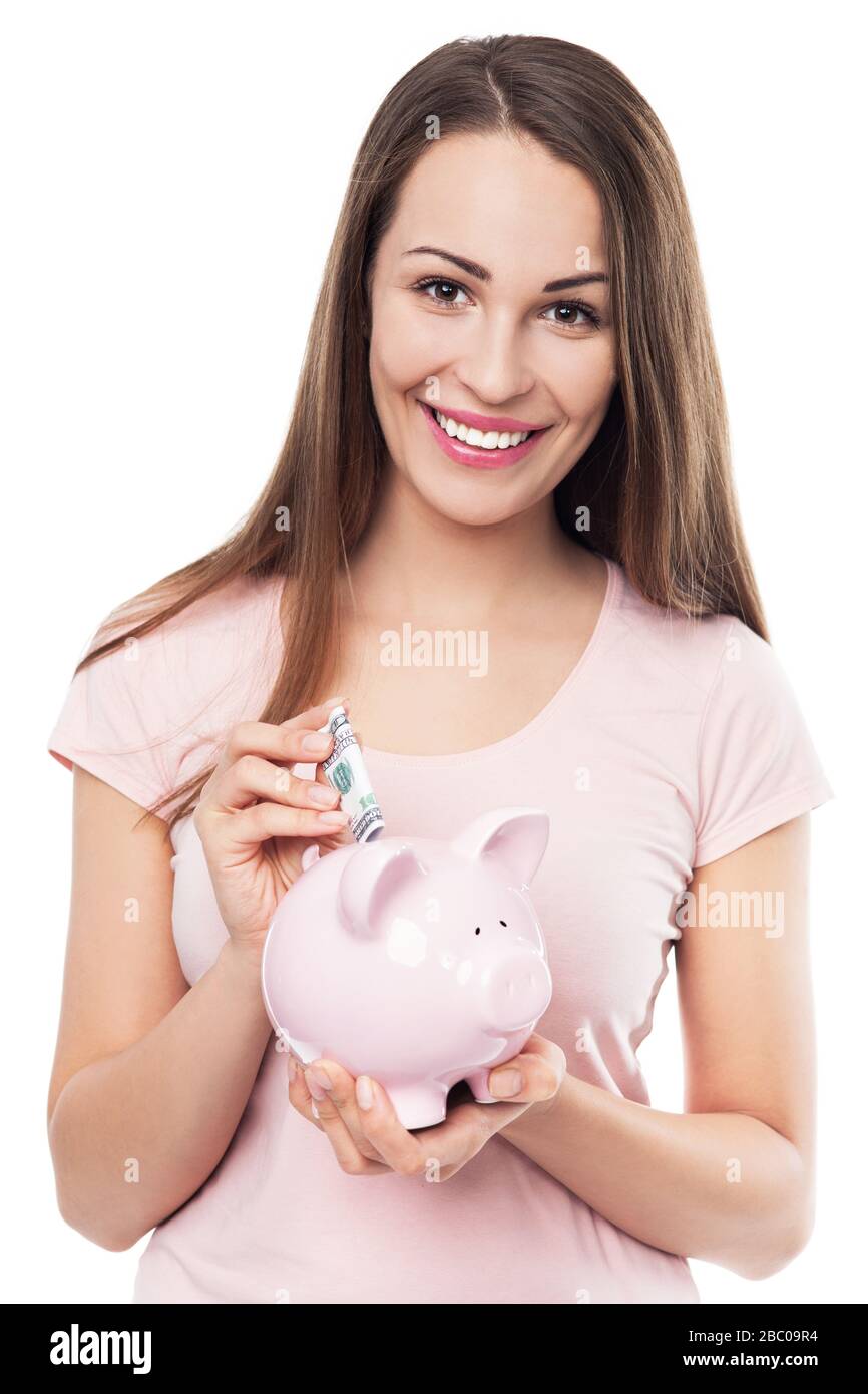 Frau verwahrenden Piggy bank Stockfoto