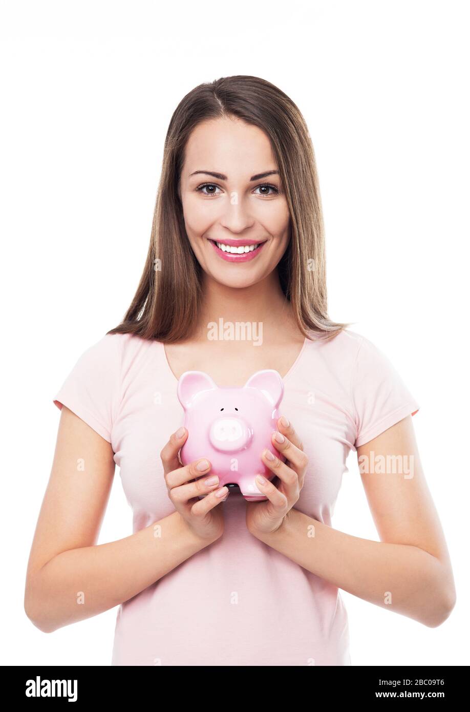 Frau verwahrenden Piggy bank Stockfoto