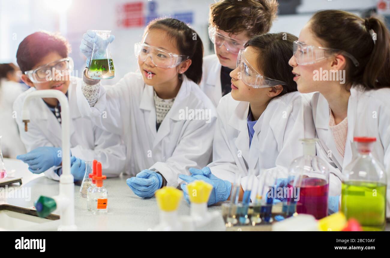 Neugierige Studenten führen wissenschaftliche Experimente durch und untersuchen Flüssigkeit im Becher im Laborunterricht Stockfoto