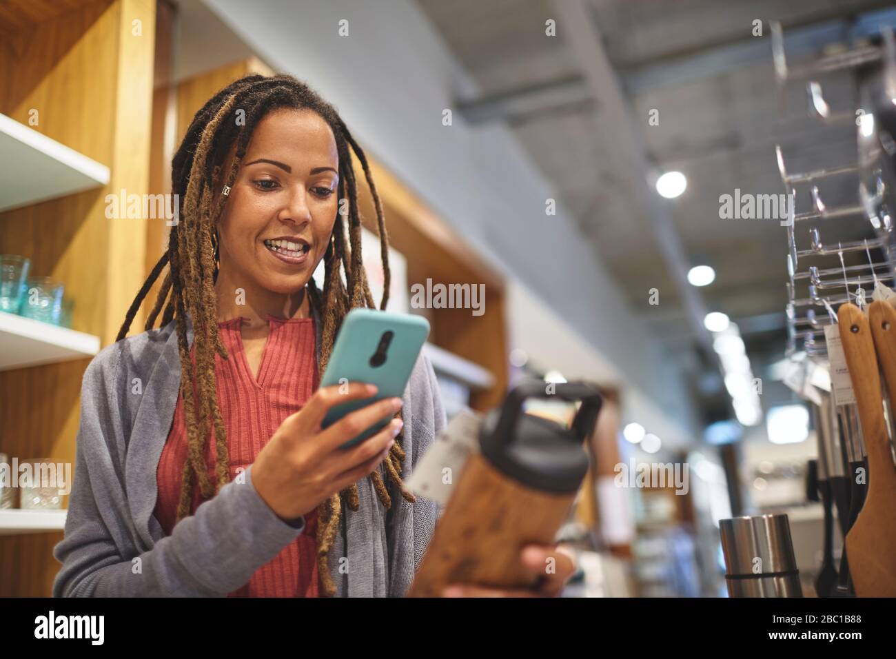 Frau mit Smart-Phone-Shopping im Warenladen zu Hause Stockfoto